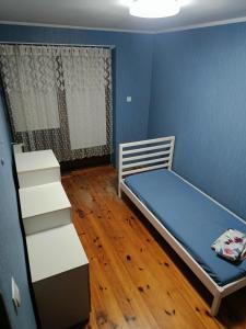 a small room with a bed and a staircase at Słoneczna Przystań in Wrocław