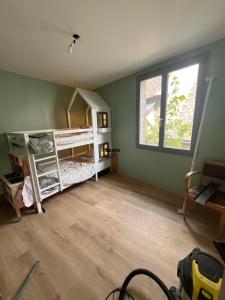 a room with two bunk beds and a window at Gite du Lac Pavin in Besse-et-Saint-Anastaise +2 photos