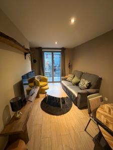 a living room with a couch and a table at Gite du Lac Pavin in Besse-et-Saint-Anastaise