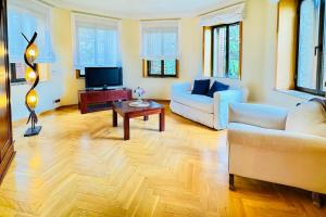 a living room with two couches and a tv at Hotel Punta me Torreblanca Palace in Guadarrama