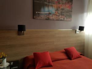 a room with a bed with two red pillows at San Carlos Hotel in Buenos Aires +37 photos