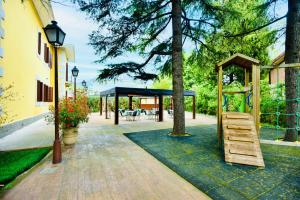 a gazebo with a bench and a tree at Hotel Punta me Torreblanca Palace in Guadarrama
