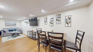 a living room with a table and chairs and a couch at Stylish Basement Suite for 4 Near Cafes & Parks - Bloor Hotel in Toronto