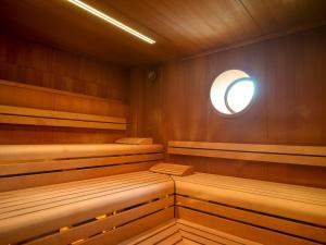 a sauna with wooden seats and a round window at Parkhotel Bremen – ein Mitglied der Hommage Luxury Hotels Collection in Bremen