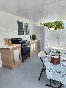 a kitchen with a table and a sink and a stove at Close to hard rock stadium and guitar casino in Pembroke Pines