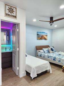 a bedroom with two beds and a bathroom at Close to hard rock stadium and guitar casino in Pembroke Pines