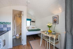 a small room with a bed and a table at Loch Ness Hideaway Pod in Lewiston