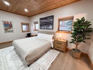 a bedroom with a bed and a potted plant at Lakefront Beauty in Rocky Point
