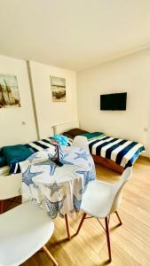 a room with a bed and a table and chairs at Apartament nr 4 przy Sali Kominkowej in Przeczyce