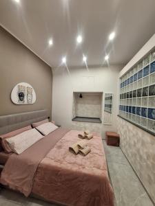 a bedroom with a large bed with two shoes on it at Casa vacanze al teatro in Catania