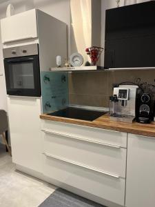 a kitchen with white cabinets and a counter with a microwave at Riverside-Appartements in Boppard