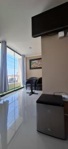 a living room with a table and chairs at Hotel Nueva Vista Huarmey in Huarmey