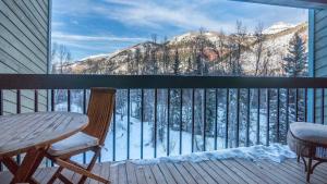 a balcony with a table and chairs and a view of a mountain at Riverside Condos C202 by AvantStay Condo Close To Downtown Town Park Ski Lift 8 in Telluride