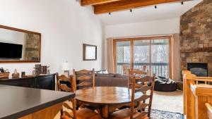 a kitchen and living room with a table and chairs at Riverside Condos C202 by AvantStay Condo Close To Downtown Town Park Ski Lift 8 in Telluride