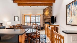 a dining room and living room with a table and chairs at Riverside Condos C202 by AvantStay Condo Close To Downtown Town Park Ski Lift 8 in Telluride