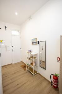 a room with white walls and a mirror at Trapani Rooms 155 Self Check in in Trapani