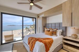 a bedroom with a bed and a large window at Luxury Unique Oceanfront Penthouse in Cabo San Lucas +78 photos