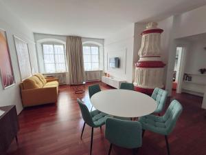 a living room with a table and a wedding cake at Atelier La Stube - Alpine Design Home in Bolzano