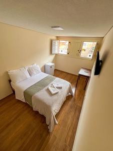 a bedroom with a bed and a wooden floor at Pousada Memórias de Minas in Ouro Preto