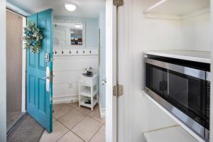 a hallway with a blue door and a television at Emerald Isle 610 Beach Front condo in Fort Walton Beach