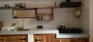 a kitchen with a sink and a stove top oven at Bungalow in El Nido +5 photos