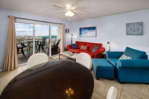 a living room with a couch and a table at Gulf Dunes 106 Gulf Front condo in Fort Walton Beach