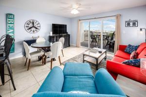 a living room with a couch and a table at Gulf Dunes 106 Gulf Front condo in Fort Walton Beach +29 photos