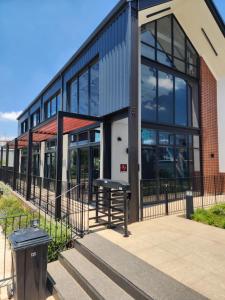 a building with a trash can in front of it at The white house in Midrand