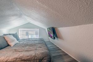 a small bedroom with a bed and a window at Tiny Home with a Huge View in Ruidoso