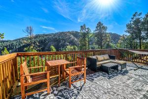 a balcony with a table and chairs and a couch at Tiny Home with a Huge View in Ruidoso
