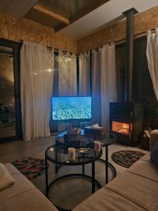 a living room with a couch and a table at Sehayleh Chalet in Ḩayy ash Shabbūq