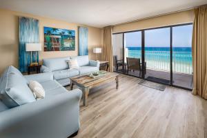 a living room with a couch and a table at Gulf Side 602 Pet friendly gulf front condo in Fort Walton Beach