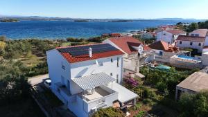 an aerial view of a white house and the water at Apartments Mirko in Ugrinići