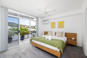 a bedroom with a bed and a large window at Nelson Towers- Overlooking The Bay in Nelson Bay +19 photos