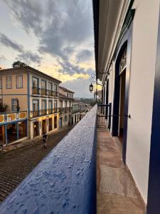 a view of a street with buildings and a blue railing at Pousada Memórias de Minas in Ouro Preto