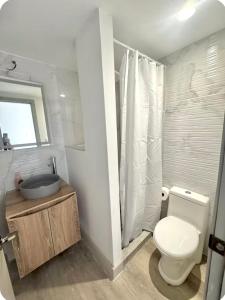 a bathroom with a toilet and a sink and a shower at Apartment 313 Ecodistrito - ZonaPRO in Tegucigalpa +12 photos