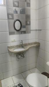 a bathroom with a sink and a toilet at Hotel Pousada Accordes in Campo Grande
