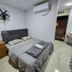 a bedroom with a bed and a fan at Cozy Private Studio DBL in ‘Ezbet `Abd el-Ḥamîd +9 photos