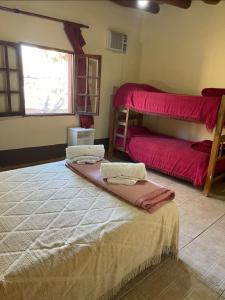 a bedroom with two bunk beds and a window at Hosteria Huaco in Huaco +102 photos