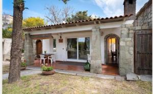 a stone house with a patio and a table at Villa Liuba con piscina in Forio d'Ischia