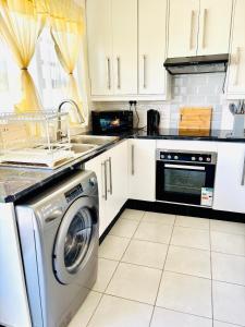 a kitchen with a washing machine and a sink at Small town comfort in Marquard