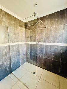 a bathroom with a shower with a glass door at Small town comfort in Marquard +5 photos