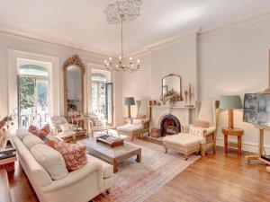 a living room with a couch and a fireplace at Elsewhere on Madison Square Manor in Savannah