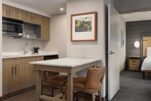 a kitchen with a table and chairs in a room at Homewood Suites by Hilton Toronto-Ajax in Ajax