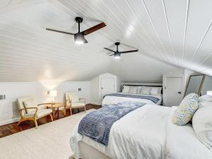a bedroom with two beds and a ceiling fan at Beachside Villa Unit 4 in Tybee Island +28 photos
