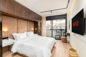 a bedroom with a large white bed and a window at Blue Chic Luxury Studio with Pool and AC in Agadir +49 photos