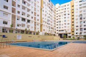 an empty swimming pool in front of buildings at Blue Chic Luxury Studio with Pool and AC in Agadir