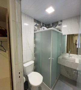 a small bathroom with a toilet and a sink at Pousada Graff in Penha