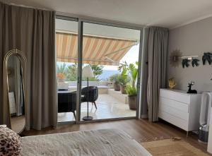 a bedroom with a sliding glass door leading to a patio at Marazul Sunset in Adeje +24 photos