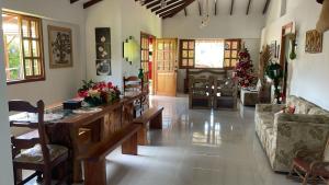 a living room with a table and a couch at Casa campestre Montenegro Quindio in Montenegro +29 photos